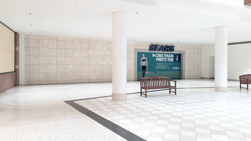 A picture of a long-since close Sears in a stark white mall setting.