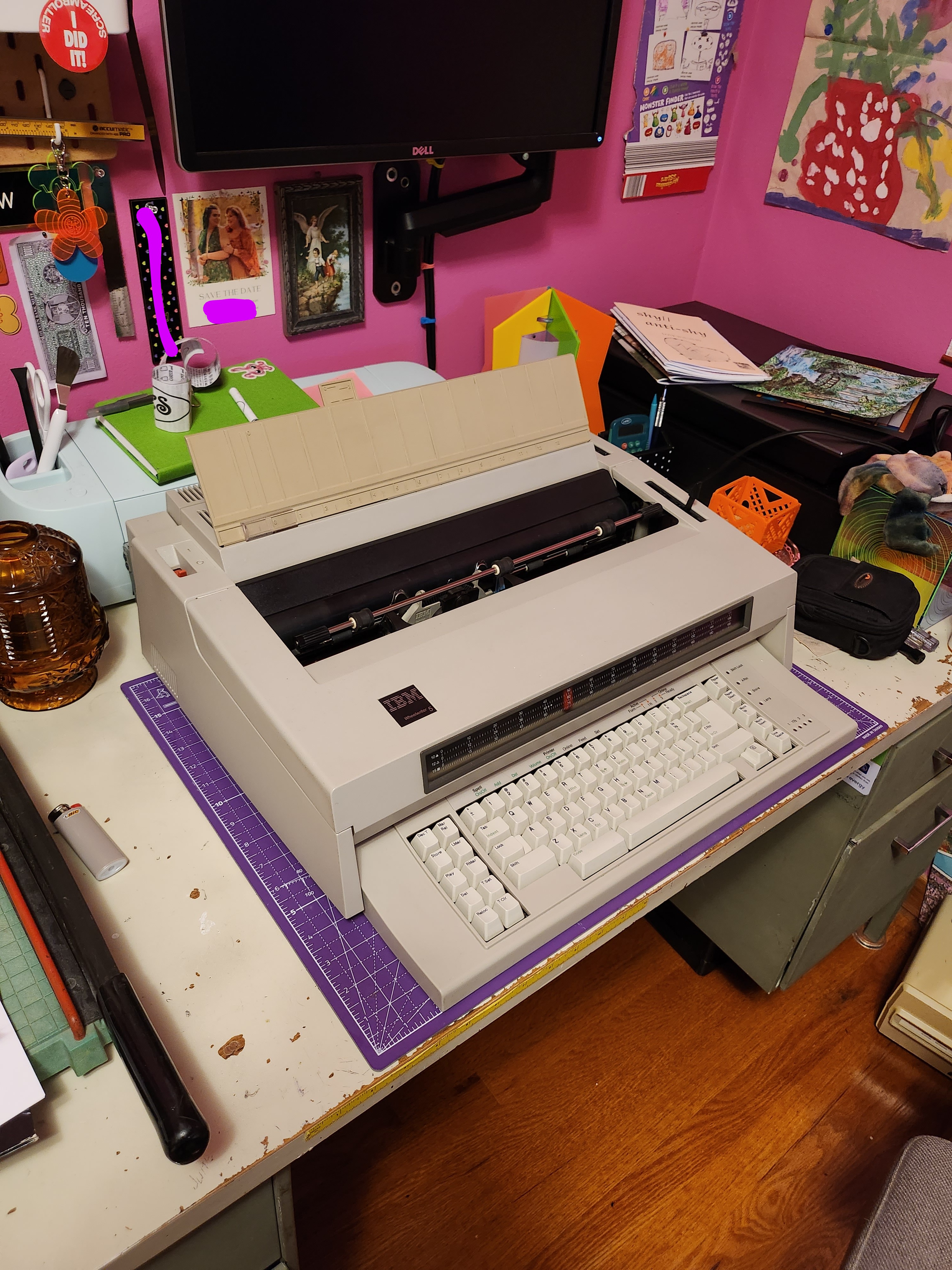A massive IBM Wheelwriter 5 typewriter in a colorful office